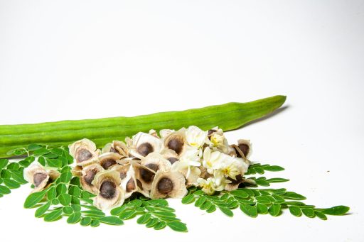 a cucumber and some flowers on a white surface