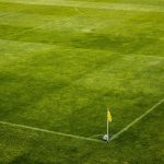 White and Black Soccer Ball on Side of Green Grass Field during Daytime