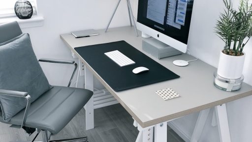 gray leather office rolling armchair beside white wooden computer desk