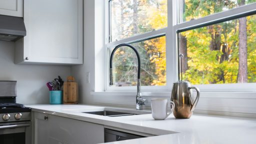 a kitchen with a sink, stove and a window
