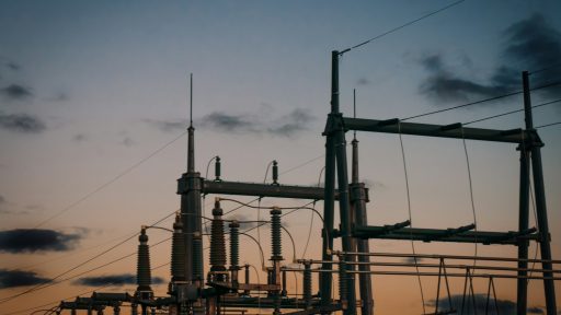 a group of power lines with a sky in the background
