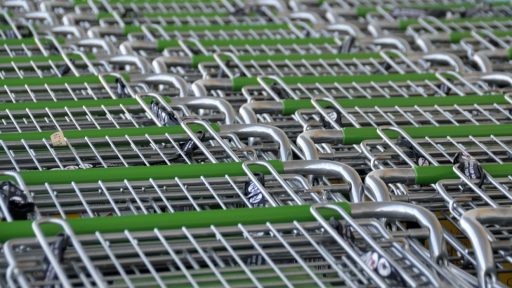 Ervaren winkelmedewerker die een nieuwe collega begeleidt tijdens de onboarding in een winkel
